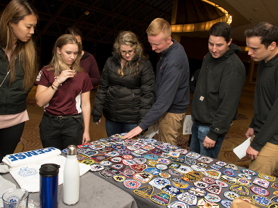 Attendees looking at patches and merchandise
