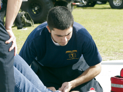 Certified EMT Julio Arango stabilizes a collapsed victim during last weeks activities fair. The EMS Club was able to respond several minutes before an ambulance could arrive. The club hopes to provide on-call EMS service on campus 24 hours a day.