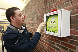 Daniel Saxe '12 inspects new defibrillator