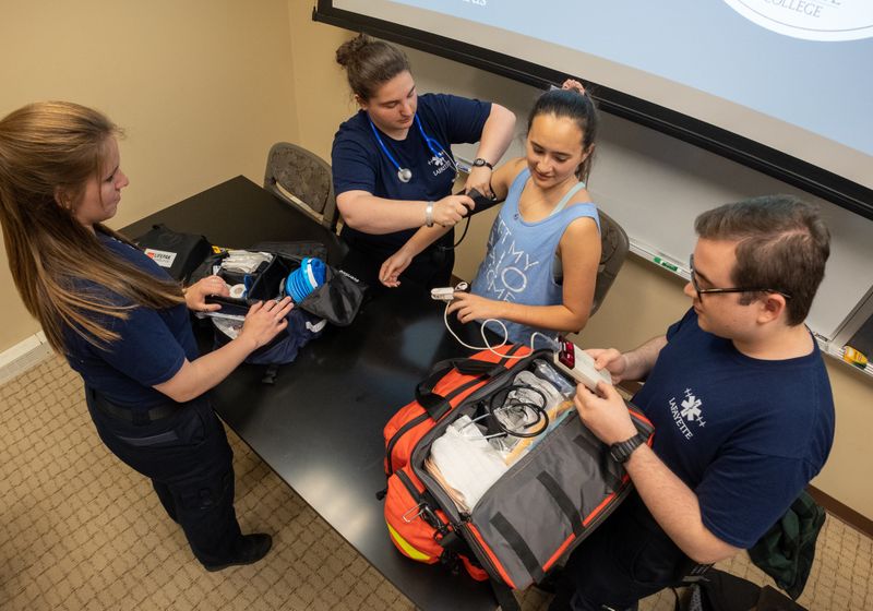 Lafayette University EMS Team members left to right, Lauren Steinitz, Rachael Broder, Karalynn Lancaster and Jonny Turovsky give a demonstration on taking blood pressure and using a pulse oximeter during the Lafayette University EMS Team's final meeting of the school year. (SHARON K. MERKEL / Special to The Morning Call)
